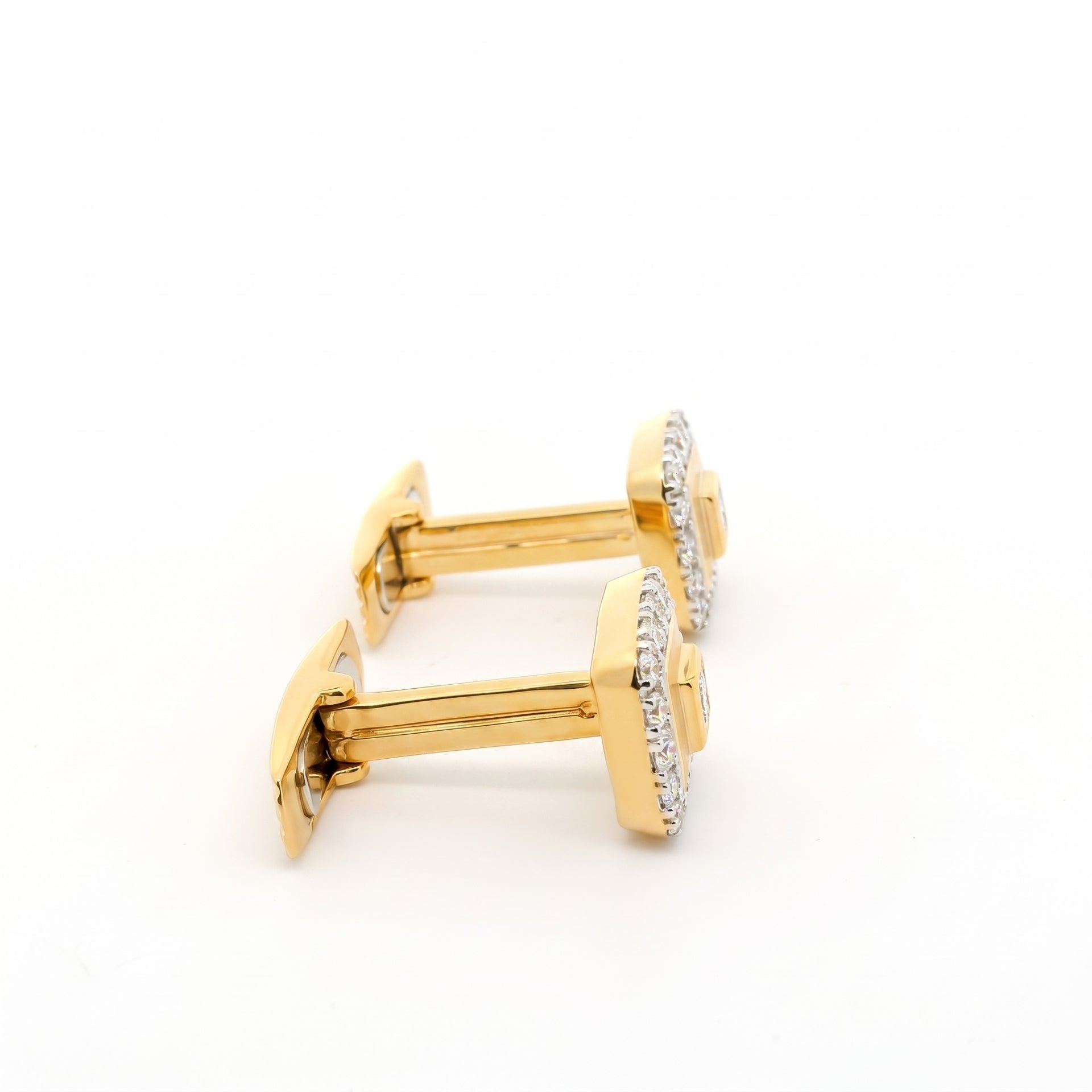 Side view of gold square shaped cufflinks with diamonds studded in centre and on the boundary.