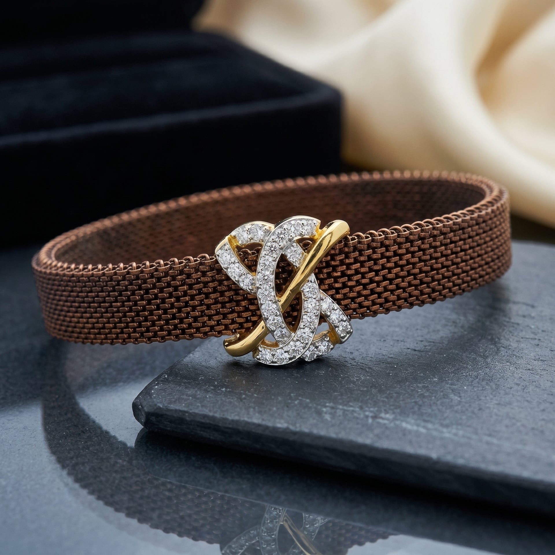 Brown woven bracelet with a decorative clasp on a dark surface