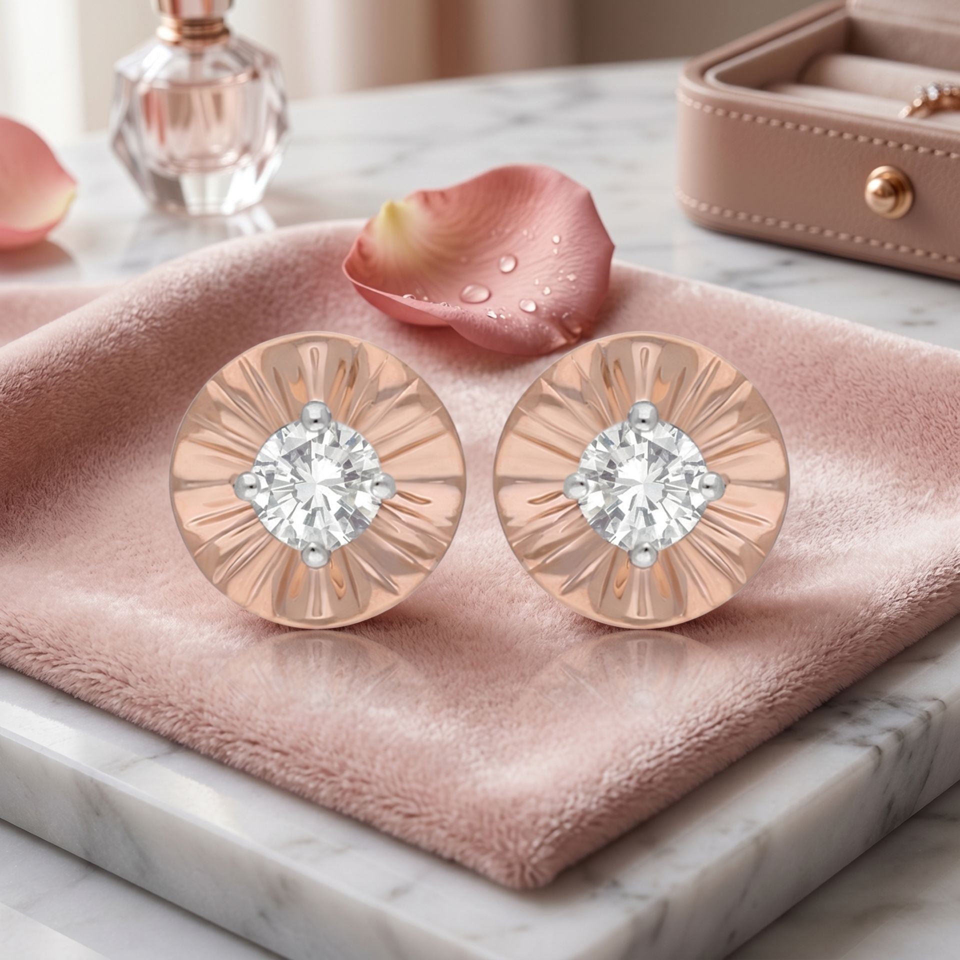 Rose gold earrings with diamonds on a pink cloth