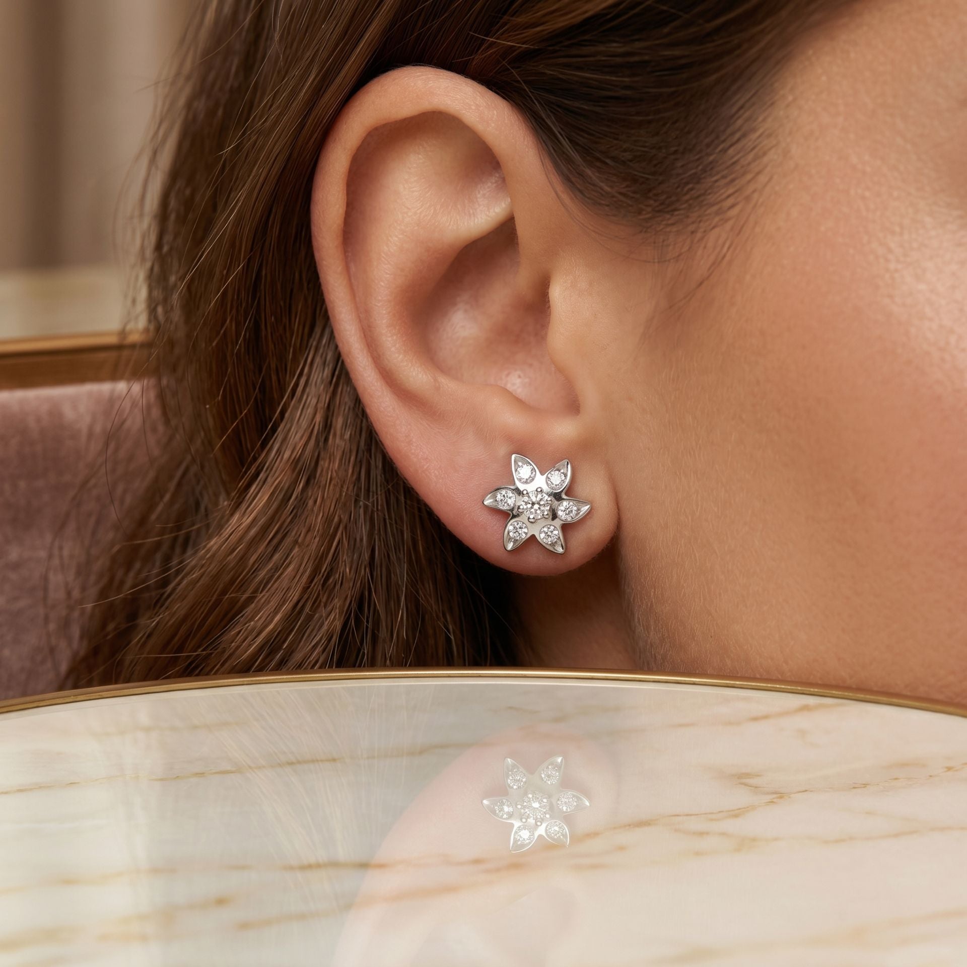 Close-up of a person wearing a star-shaped earring with a blurred background
