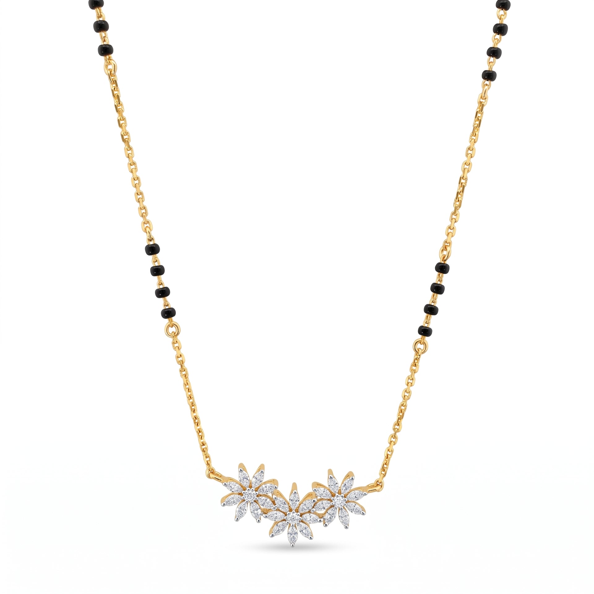 A gold chain necklace with a black bead accent and a central cluster of three flower pendants set with clear stones, shown on a plain white background.