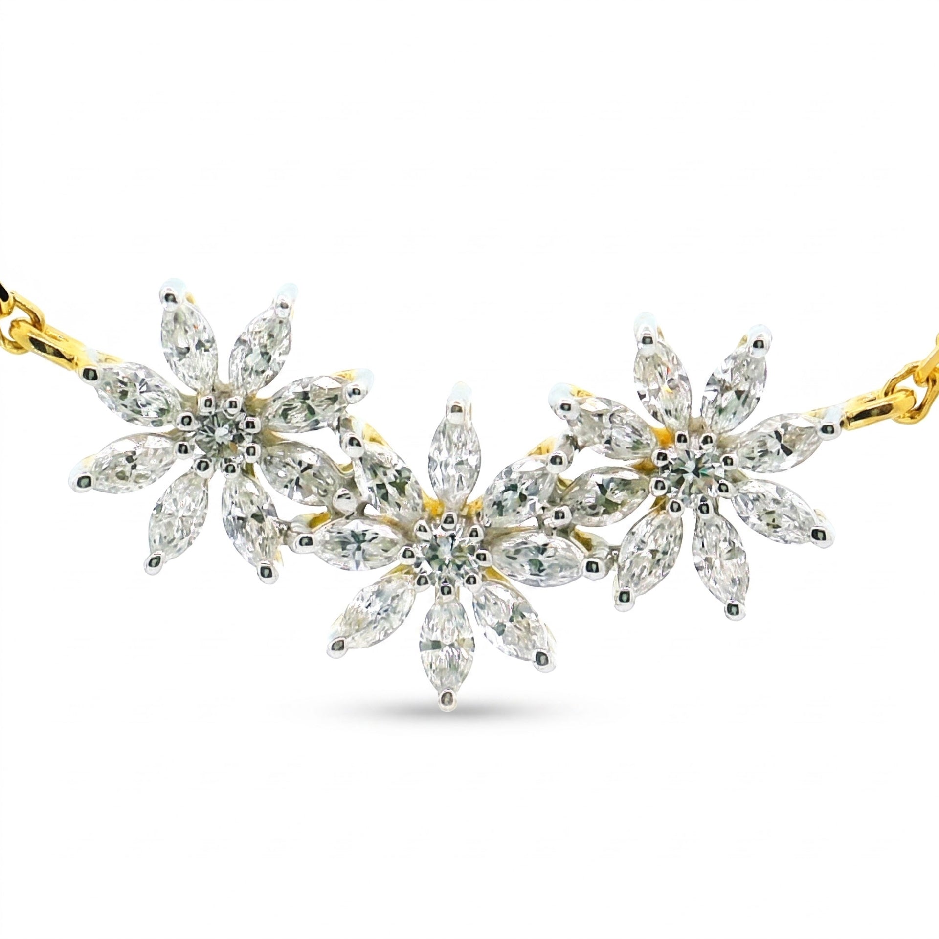 A gold and silver floral necklace featuring marquise-cut clear gemstones in a daisy chain pattern, displayed on a clean white background.