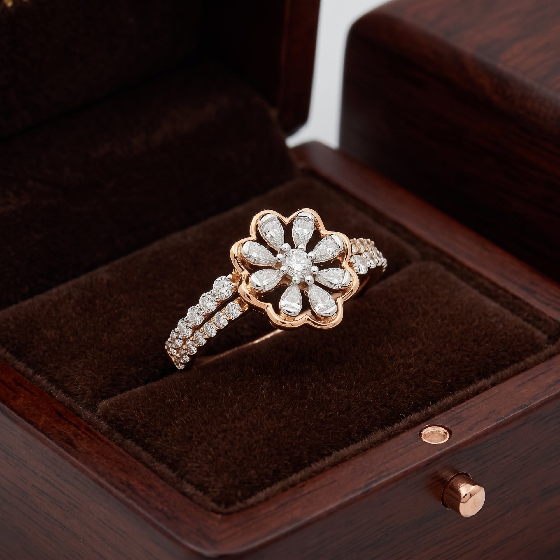 Rose gold ring with diamonds on a brown velvet cushion in a wooden box