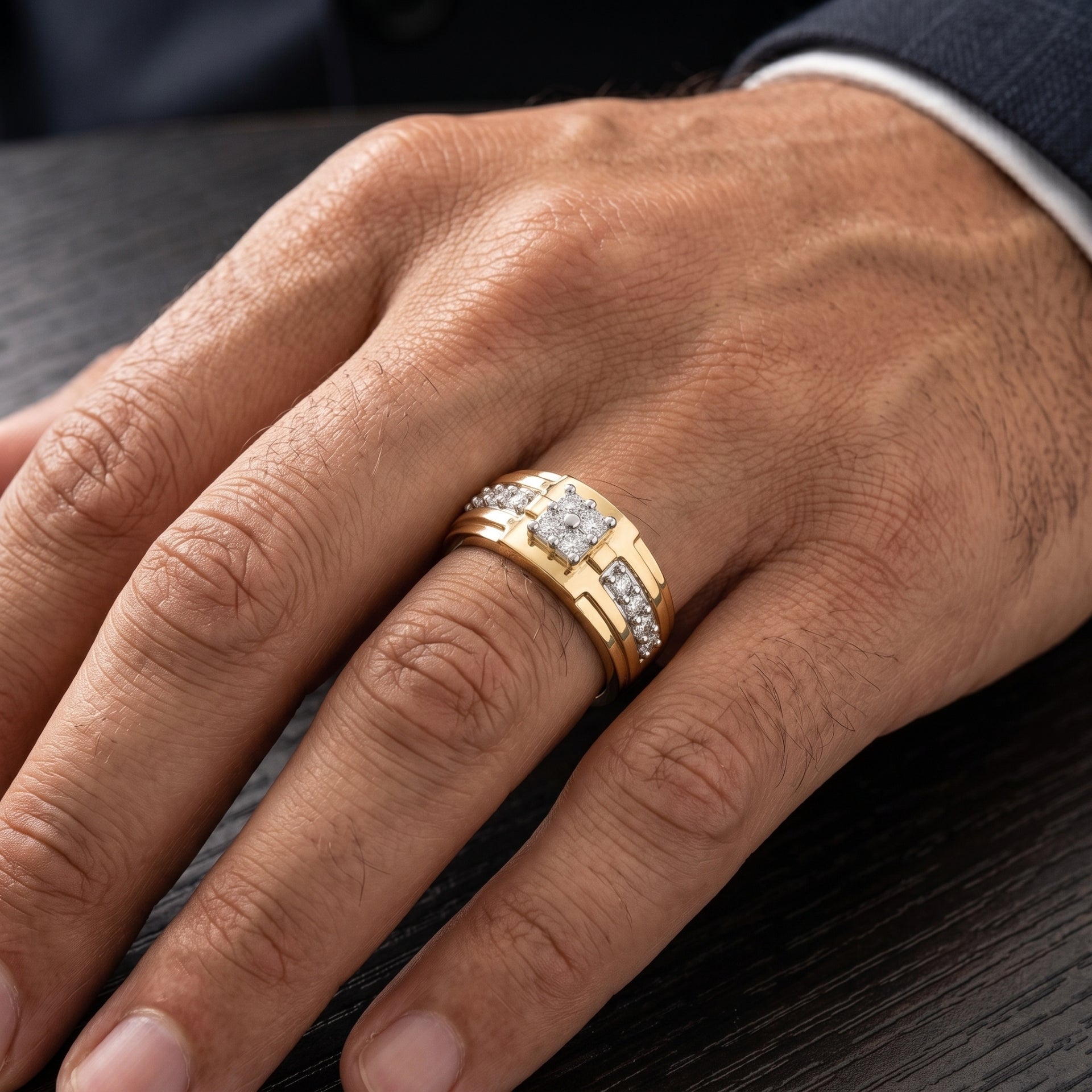 Close-up of a hand wearing a gold ring with diamonds on a dark surface