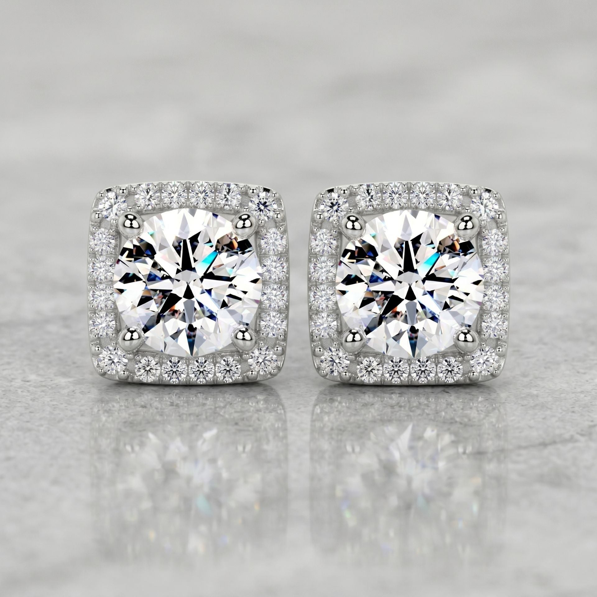 Square halo stud earrings featuring brilliant round lab-grown diamonds surrounded by a sparkling diamond halo on a polished marble surface.