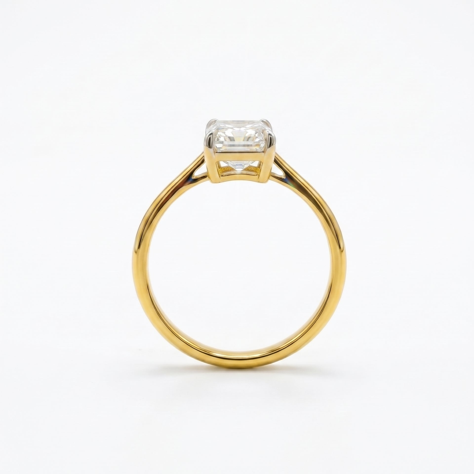 Gold ring with a diamond on a white background