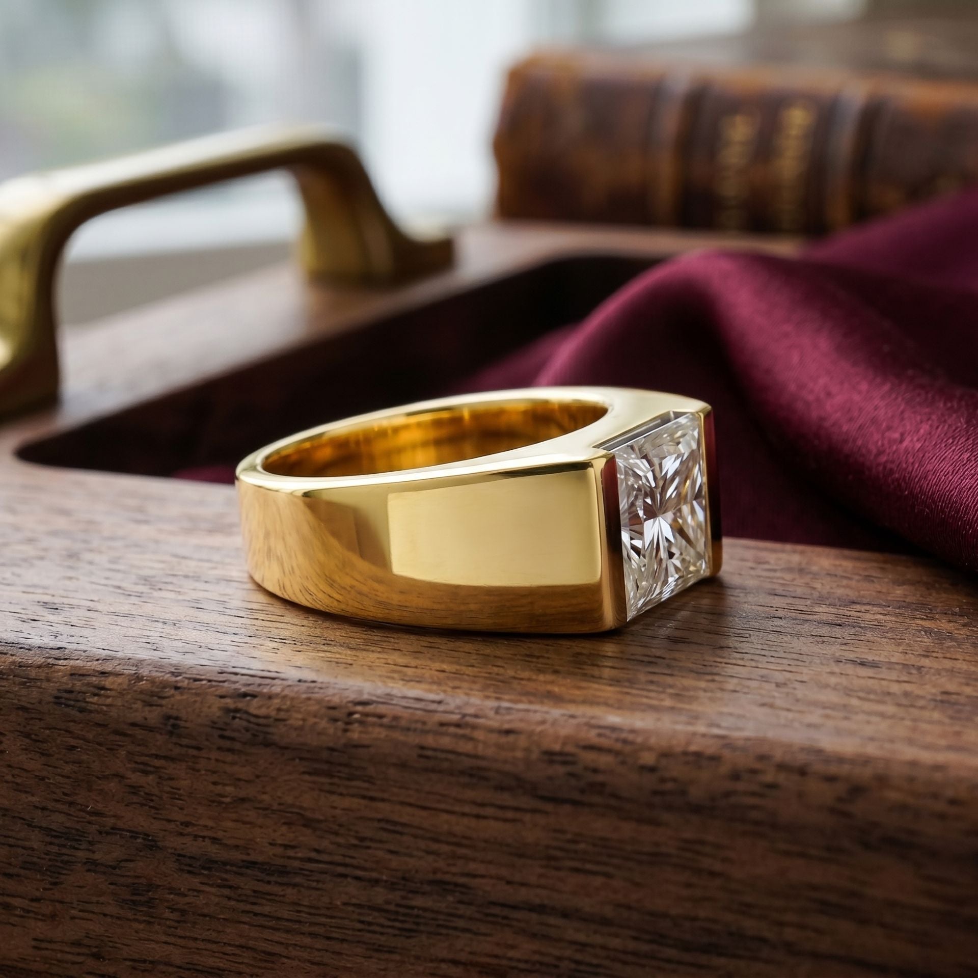 Gold ring with a diamond for men on a wooden surface