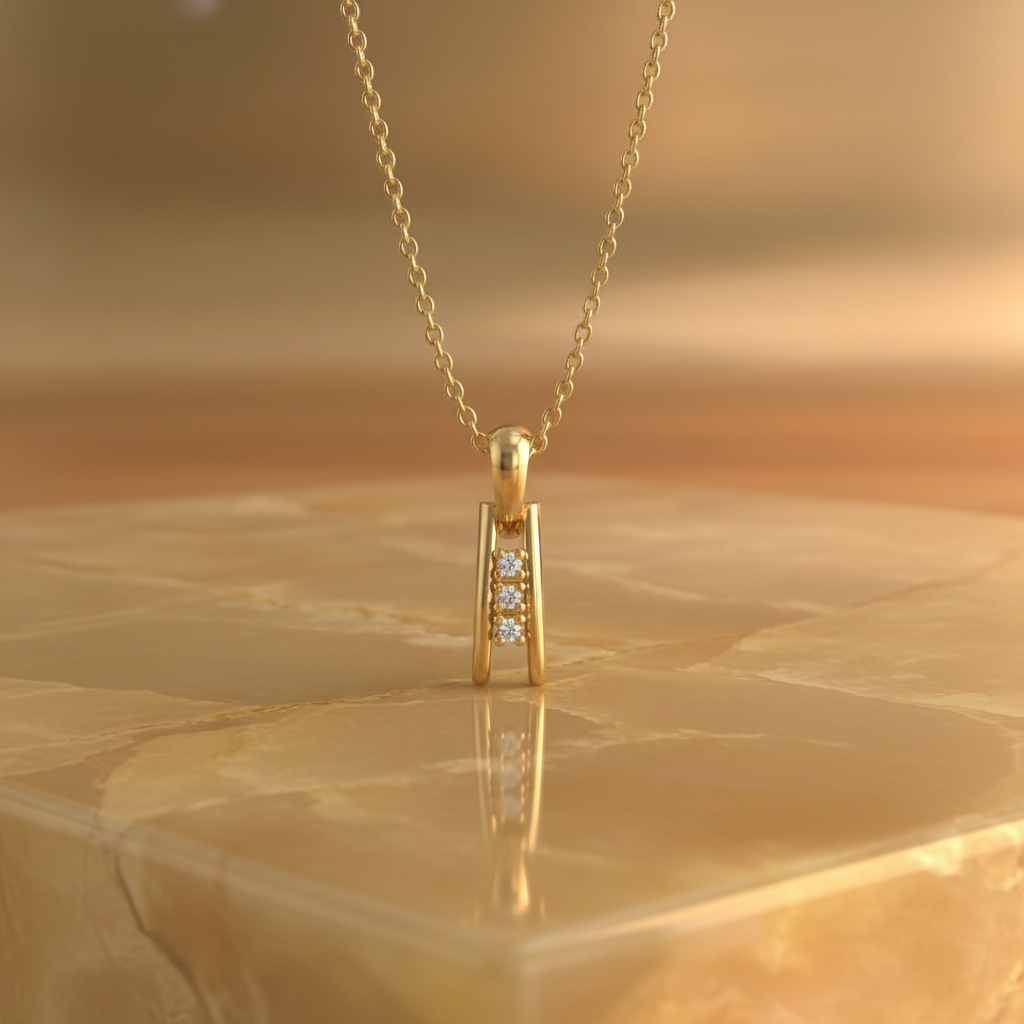 Gold necklace with a pendant on a marble surface