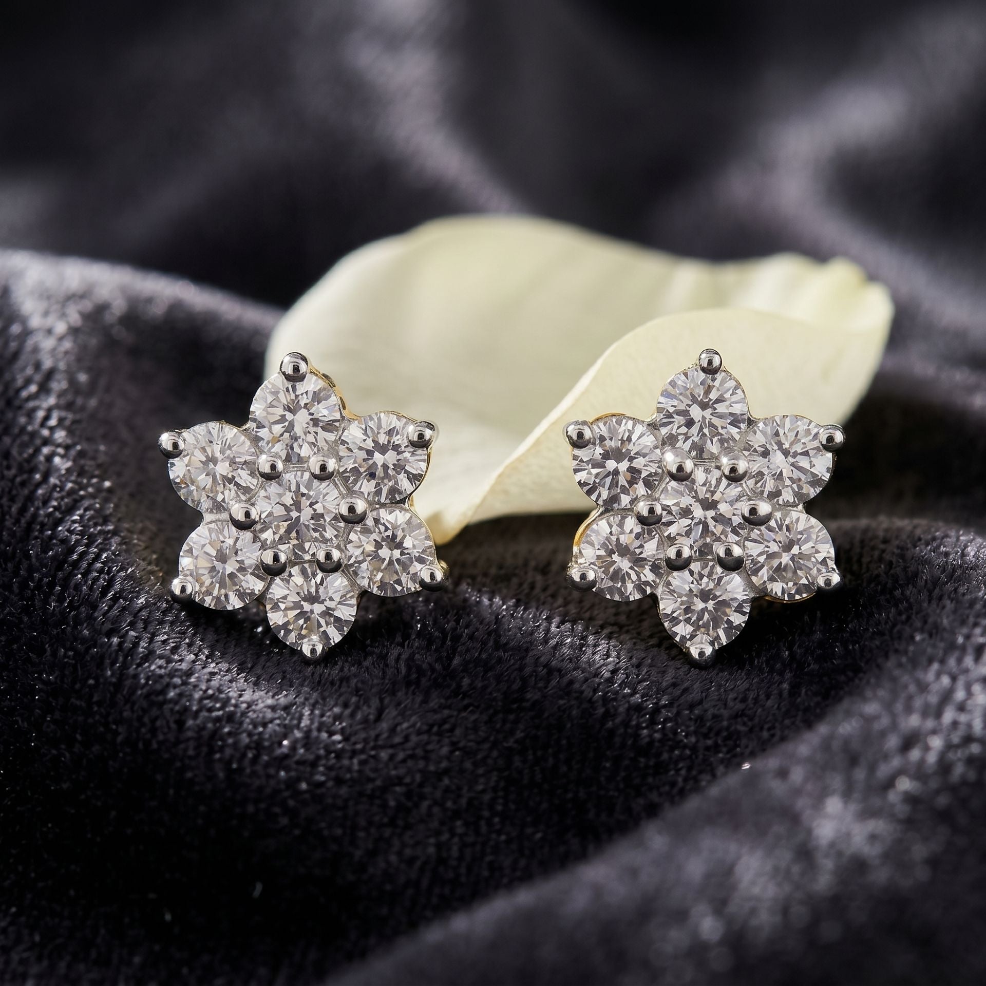 Floral lab grown diamond stud earrings on a dark velvet background
