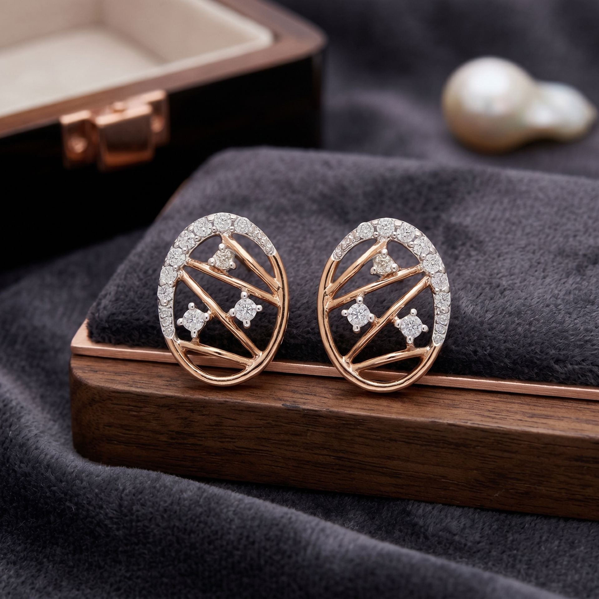 Rose gold geometric lab grown diamond stud earrings on a wooden display