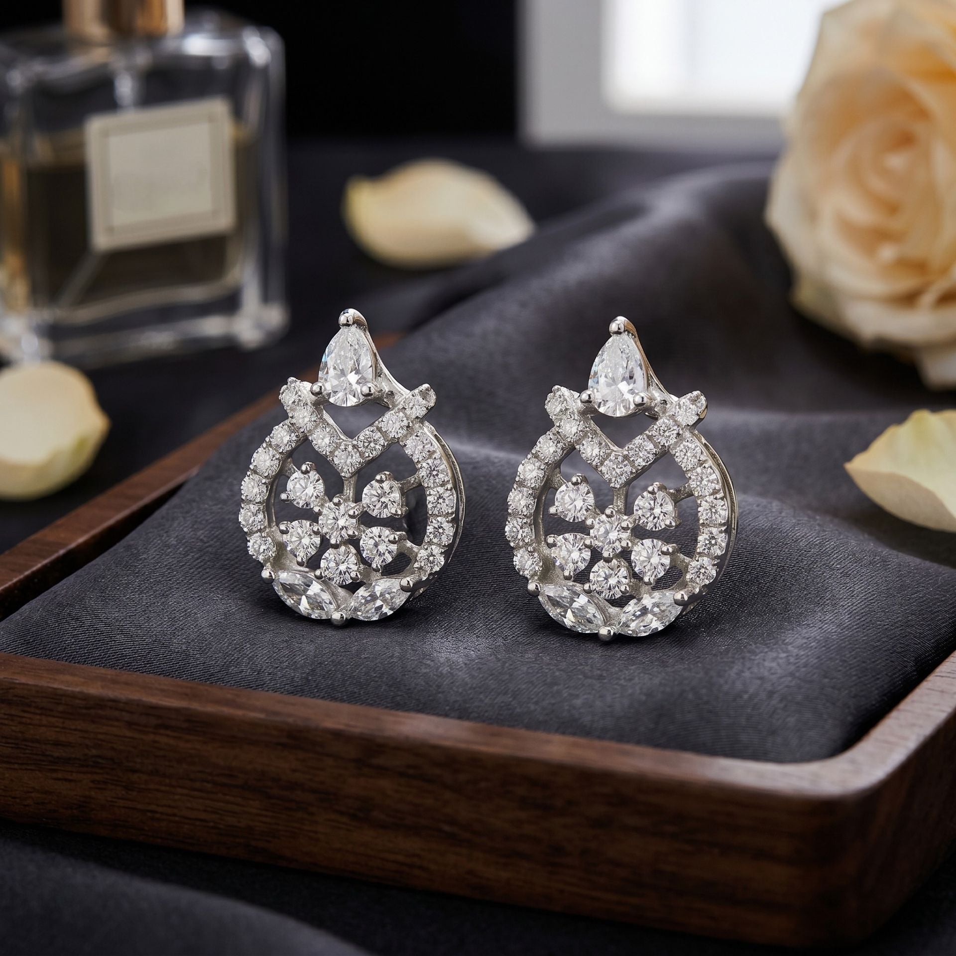 Lab grown diamond drop earrings displayed on a dark wooden surface