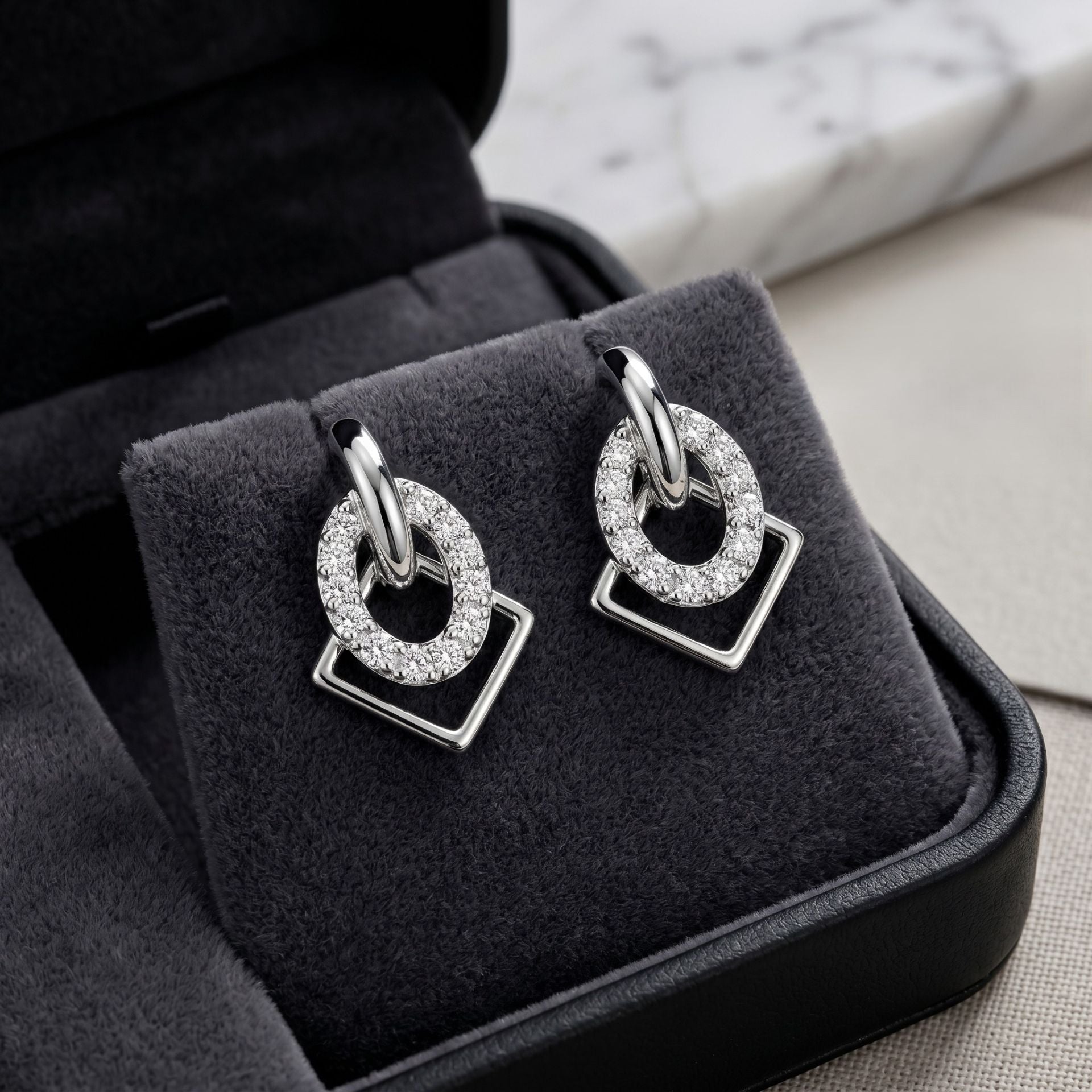Black gemstone drop earrings with sparkling lab-grown diamonds displayed on a luxury jewelry stand.