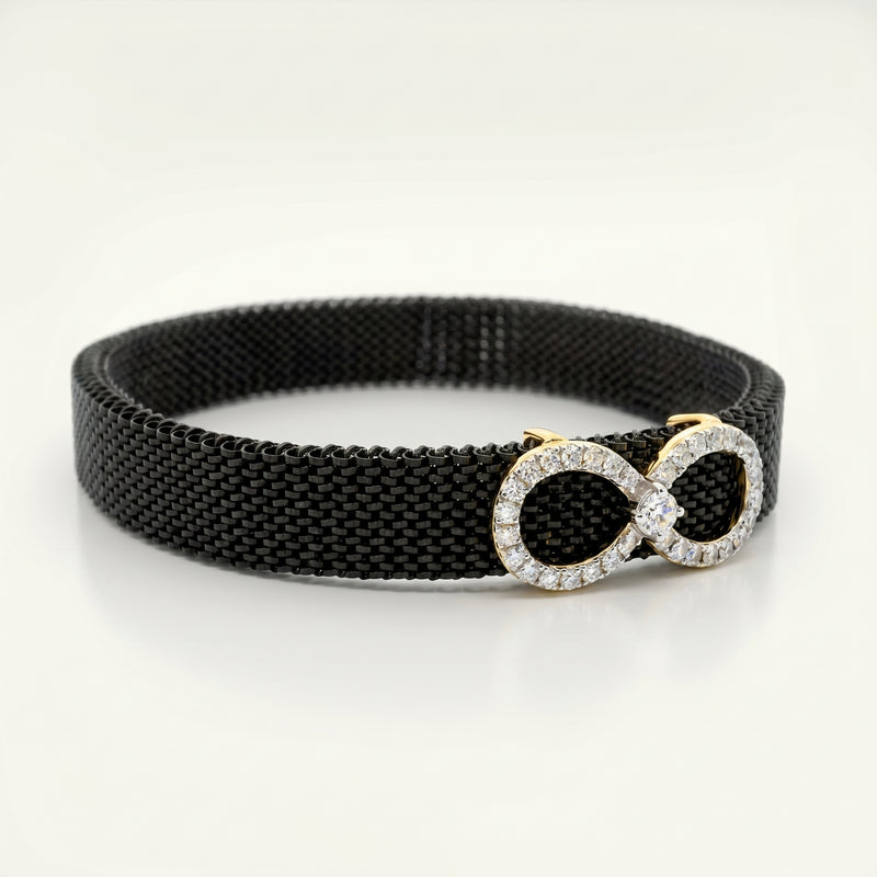 Black woven belt with a gold and diamond-studded buckle on a white background