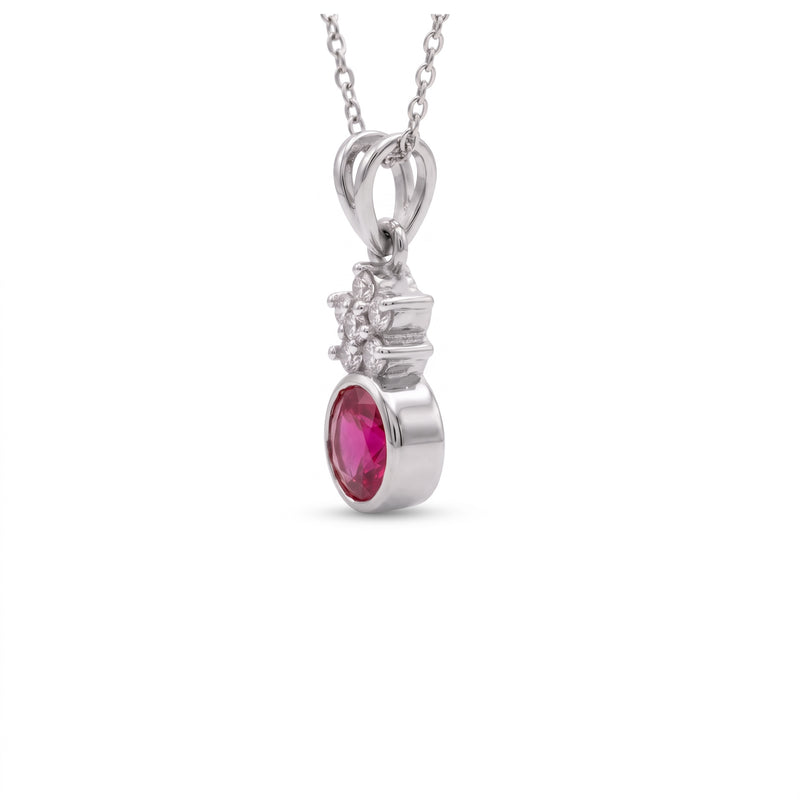 A silver pendant necklace featuring a round pink gemstone and small clear accent stones, shown on a plain white background.