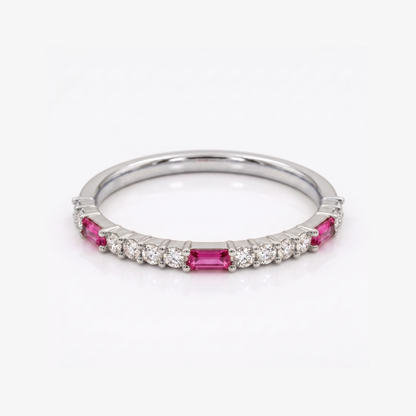 A silver band ring featuring rectangular pink gemstones and small round clear stones, photographed on a clean white background.