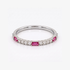 A silver band ring featuring rectangular pink gemstones and small round clear stones, photographed on a clean white background.