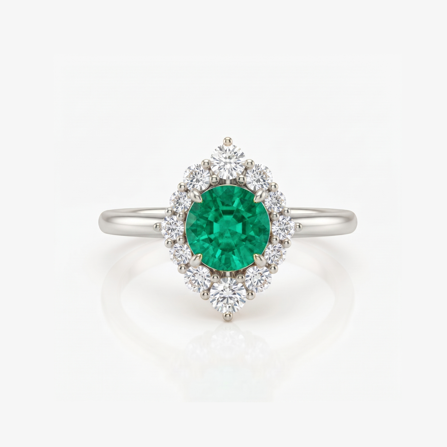 A silver ring featuring a round green emerald-cut center stone surrounded by a halo of round clear stones, set on a polished silver band against a white background.