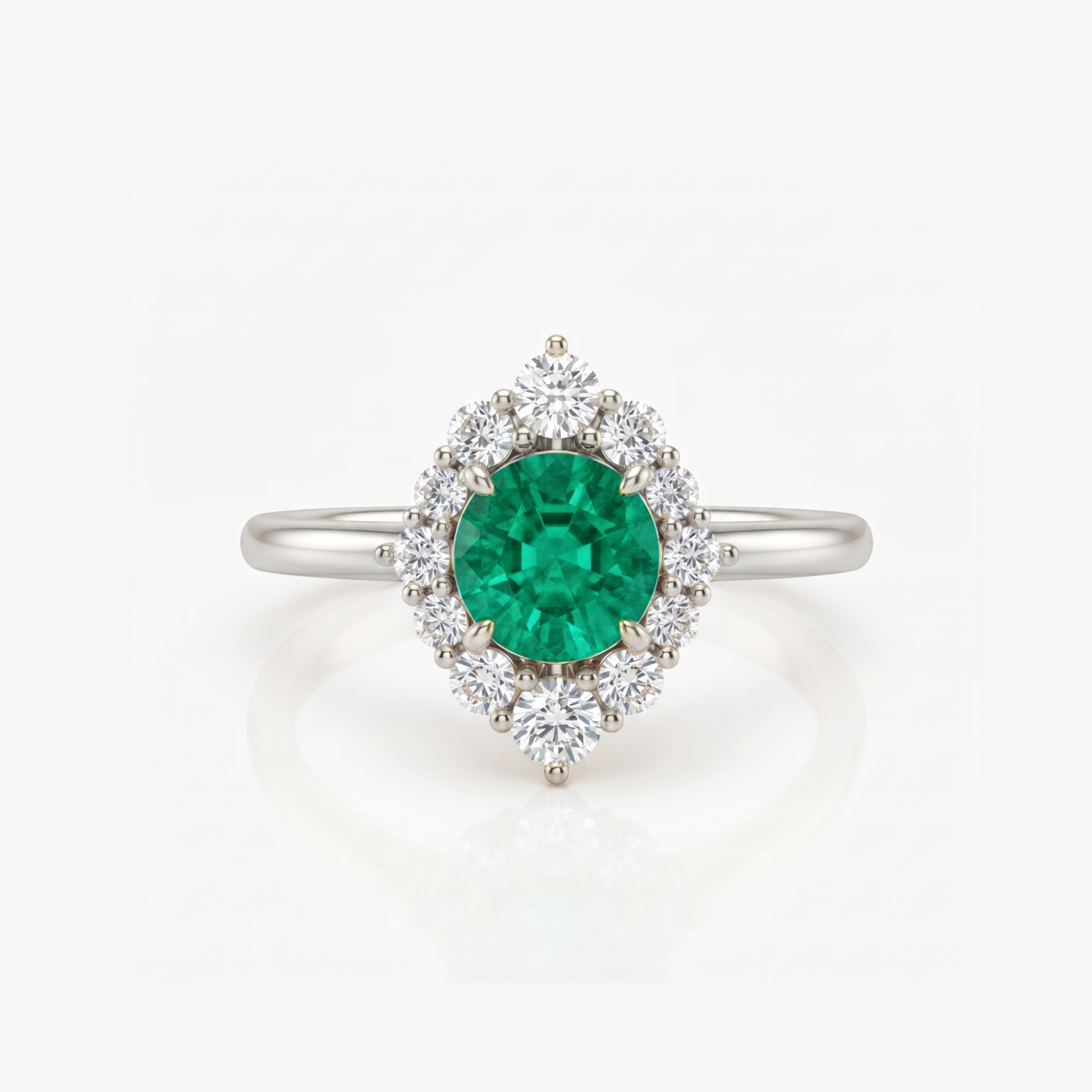 A silver ring featuring a round green emerald-cut center stone surrounded by a halo of round clear stones, set on a polished silver band against a white background.