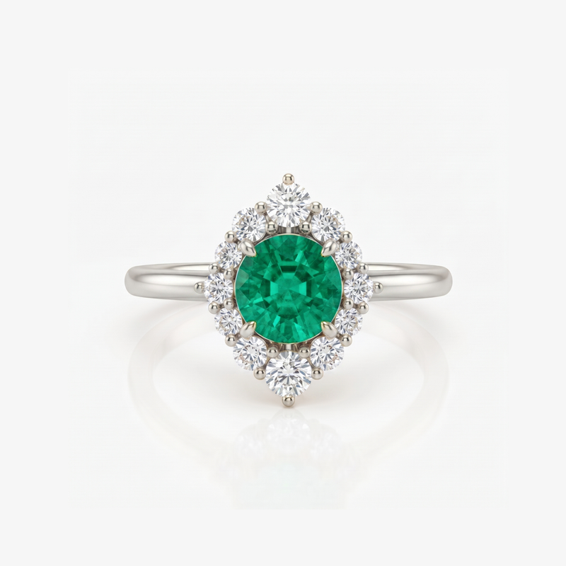 A silver ring featuring a round green emerald-cut center stone surrounded by a halo of round clear stones, set on a polished silver band against a white background.