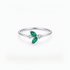 A silver ring featuring two marquise-cut green emeralds and small clear accent stones, set on a polished silver band against a clean white background.