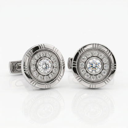 A pair of round silver-toned cufflinks featuring a central round diamond surrounded by a halo of smaller diamonds, set in a circular textured bezel.