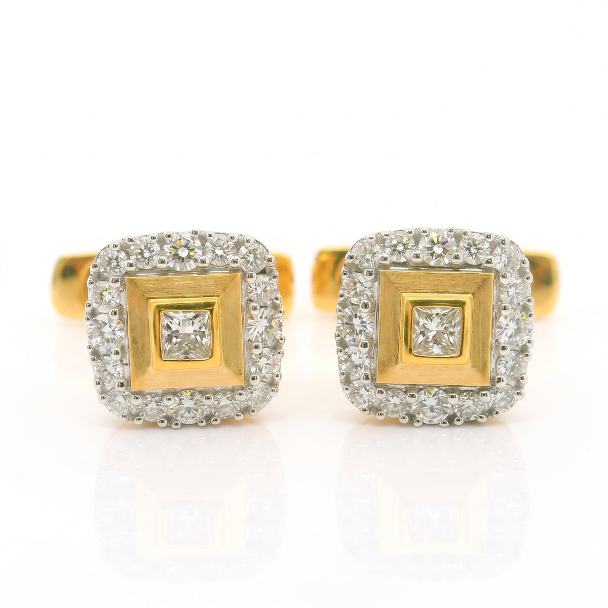 Gold square shaped cufflinks with diamonds studded in centre and on the boundary. 