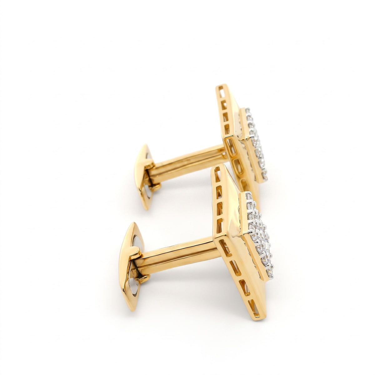 A pair of gold cufflinks with clear pavé diamond accents, shown on a clean white background.