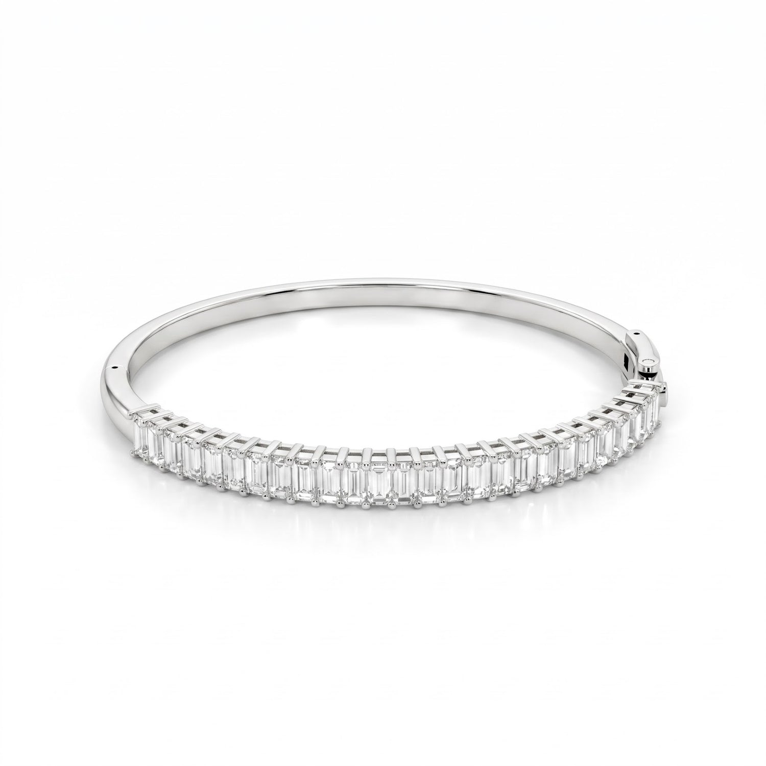 A slim silver bangle bracelet featuring a continuous row of baguette-cut clear stones along the front band, set against a clean white background.
