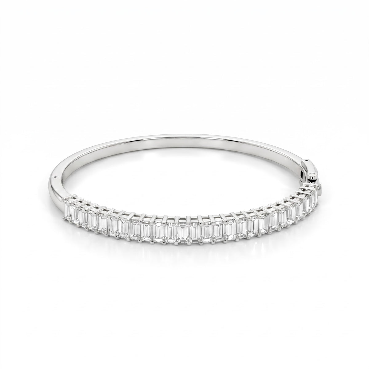 A slim silver bangle bracelet featuring a continuous row of baguette-cut clear stones along the front band, set against a clean white background.