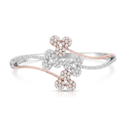 A delicate open bangle bracelet featuring three floral clusters of clear pavé stones set in rose gold and white gold, displayed on a clean white background.