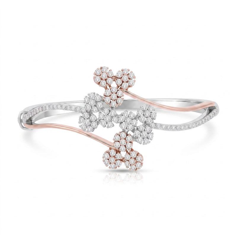 A delicate open bangle bracelet featuring three floral clusters of clear pavé stones set in rose gold and white gold, displayed on a clean white background.