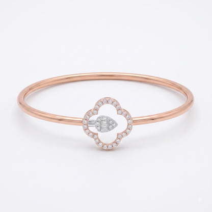 A rose gold bangle bracelet featuring a central clover-shaped charm with a diamond halo and a central diamond-set geometric accent, shown on a clean white background.