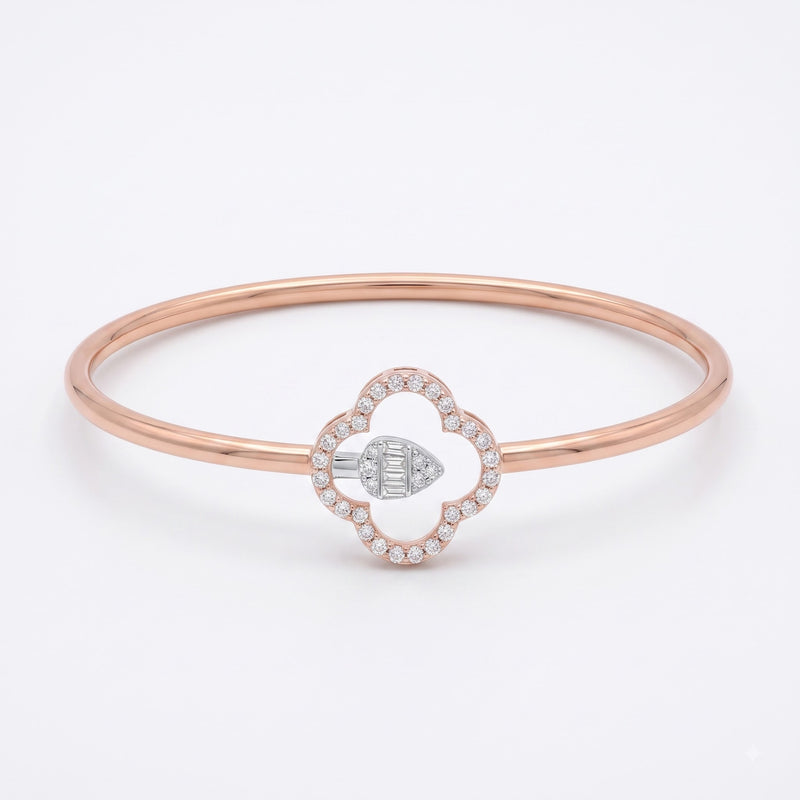 A rose gold bangle bracelet featuring a central clover-shaped charm with a diamond halo and a central diamond-set geometric accent, shown on a clean white background.