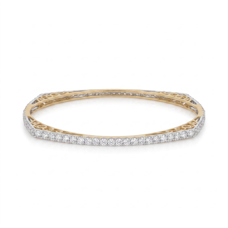 A yellow gold bangle bracelet featuring a continuous row of pavé-set round diamonds on the outer band, with an openwork filigree gold inner band, shown against a plain white background.