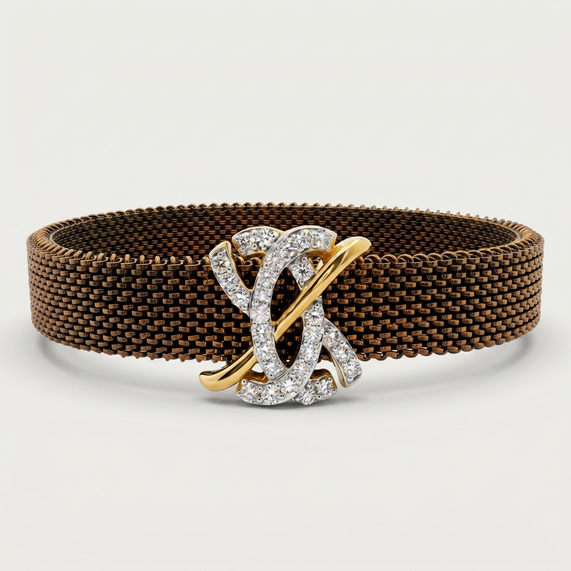 Brown woven bracelet with a gold and silver clasp on a light gray background.