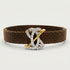 Brown woven bracelet with a gold and silver clasp on a light gray background.