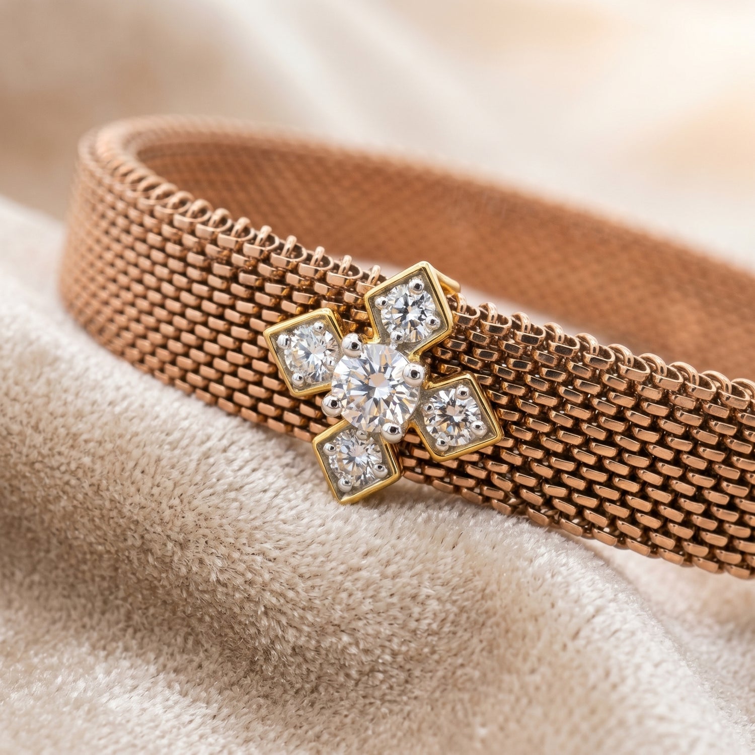 Close-up of a rose gold mesh bracelet with floral diamond detail