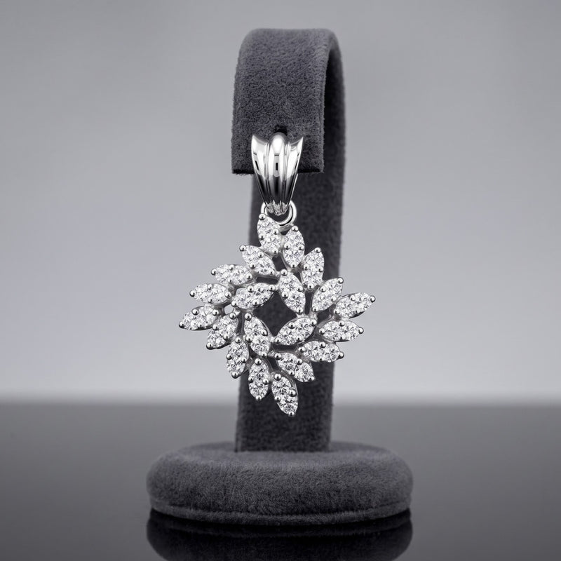 A silver snowflake-shaped pendant encrusted with clear stones, displayed on a dark gray velvet jewelry stand against a neutral gray background.