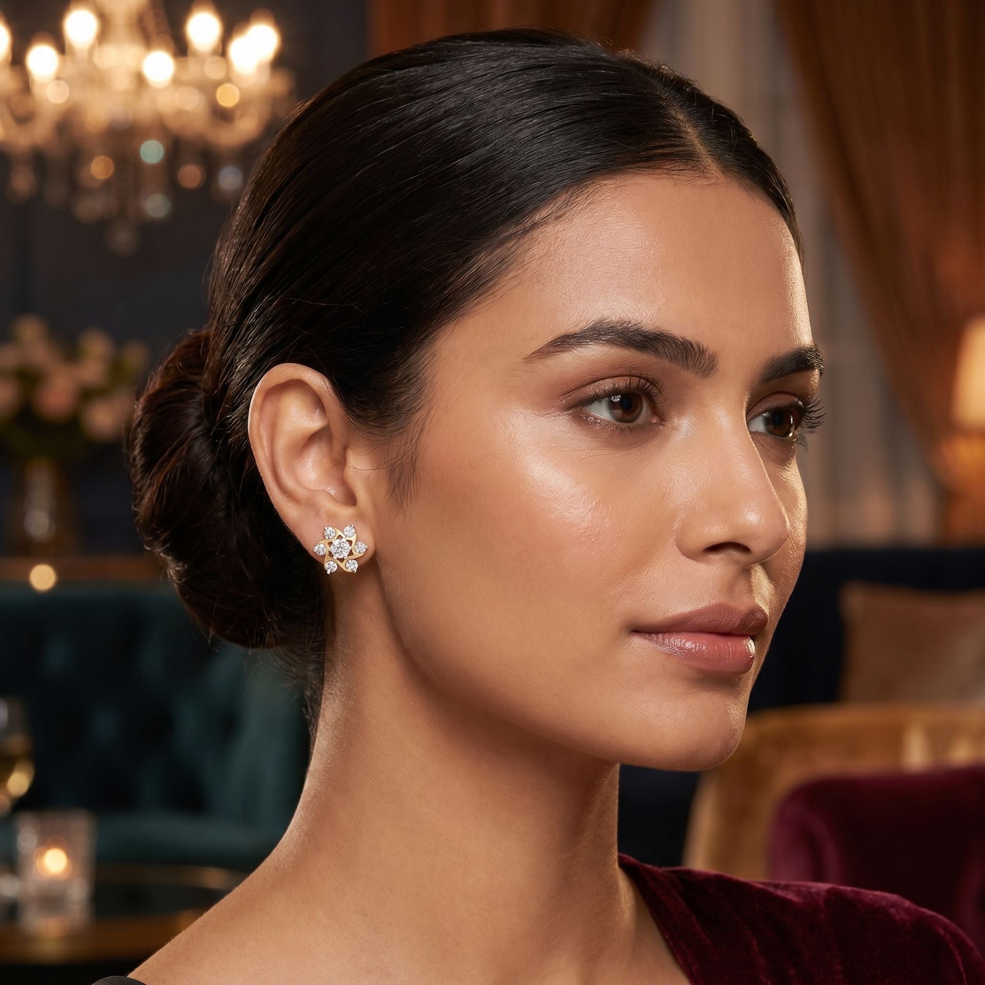Woman wearing earrings in an elegant indoor setting