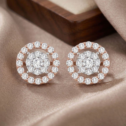 Pair of diamond earrings on a soft fabric background