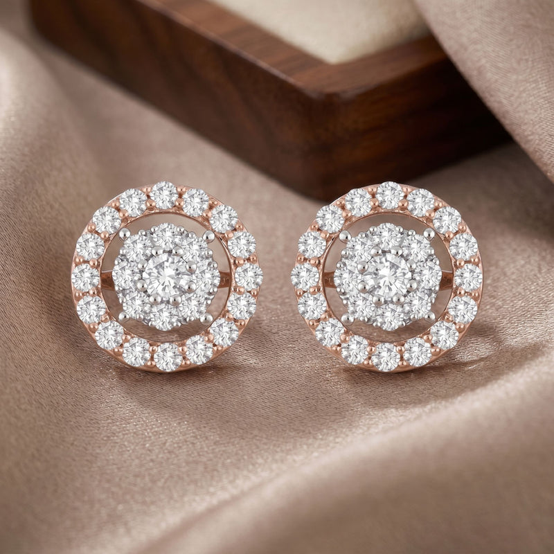 Pair of diamond earrings on a soft fabric background