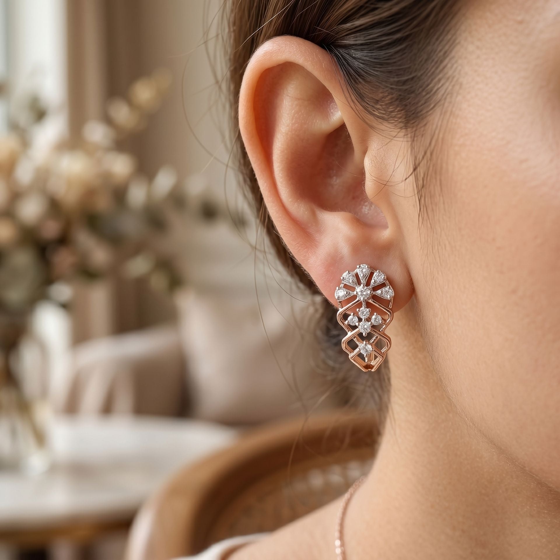 Close-up of a person wearing a diamond earring with a blurred indoor background