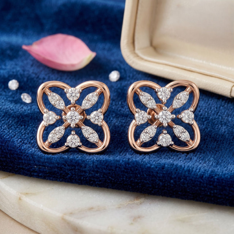 Rose gold floral stud earrings featuring sparkling lab-grown diamonds on a blue velvet jewelry display beside an open jewelry box.
