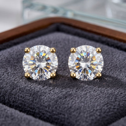 Pair of diamond stud earrings on a textured surface