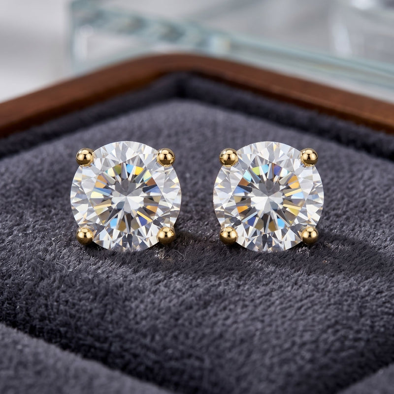 Pair of diamond stud earrings on a textured surface