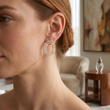 Close-up of a woman wearing a decorative earring in a home setting