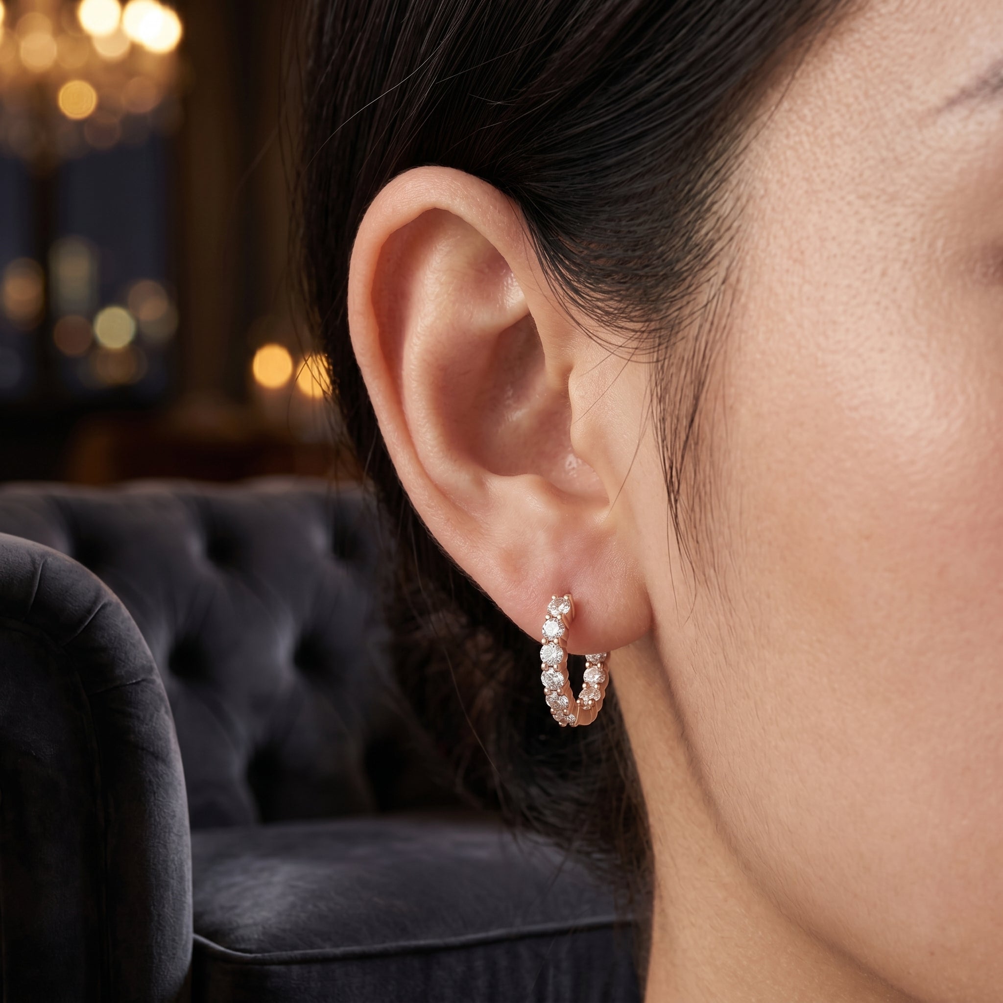 Woman wearing elegant geometric lab-grown diamond stud earrings in a side profile portrait.