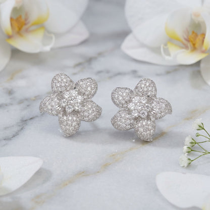 Floral lab grown diamond stud earrings on a marble background