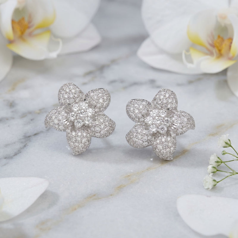 Floral lab grown diamond stud earrings on a marble background