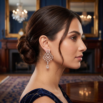 Woman wearing elegant earrings in a luxurious room with chandeliers.